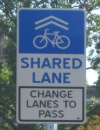 Exemplo de sinalização de compartilhamento da via e ultrapassagem segura (do inglês pista compartilhada, troque de pista para ultrapassar). Fonte: Cincinnati's Bike Friendly Infrastructure.