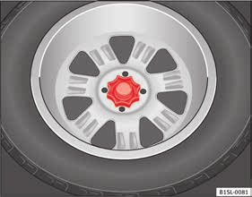 Roda suplente ou roda de emergência* Fig. 176 Na bagageira: roda de mão para a fixação do pneu suplente. Retirar o pneu suplente Abrir a porta da mala e levantar a chapeleira do mesmo Página 125.