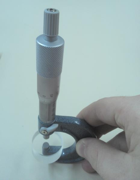 O paralelo óptico deve ser colocado entre as faces de medição, sob a pressão da catraca ou do acionamento de fricção.