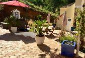 Bougainvilleas, palms and passionflowers surround the swimming pool, a beautiful