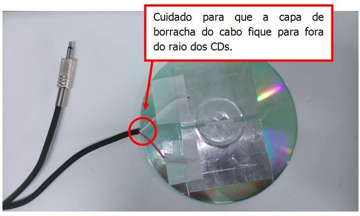 Figura 16 - Extremidades do cabo fixadas nas membranas do CD Após a fixação dos fios, junte os dois CDs com fita dupla face.