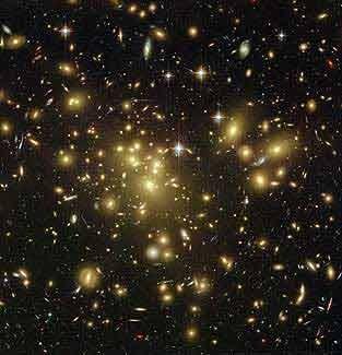 Matéria Escura Zwicky (1933): há muito mais massa nos aglomerados que a que podemos atribuir à matéria conhecida: a ME A maior parte da ME não pode ser bariônica!