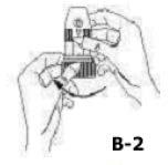 CARREGAMENTO: Figura B-1: Mantenha o aparelho em posição vertical, aperte o botão marrom do bocal com uma mão e com a outra, gire o corpo do