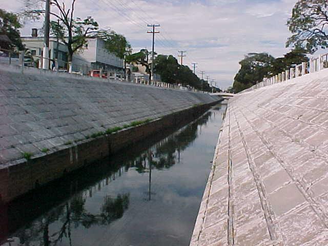 Este trecho do canal apresenta uma calha retangular em concreto, com dimensões de 4 m x 2 m, que se abrem em taludes tipo 2:1, numa seção trapezoidal de 4 m x 12 m x 5 m.