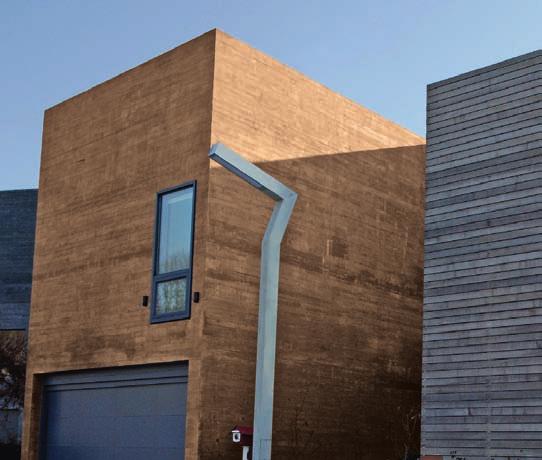 Uma galeria entre a arte e a natureza Edifício de editora e prédio de habitação de um diretor de cinema, em concreto colorido de marrom (à base de pigmentos Bayferrox ).