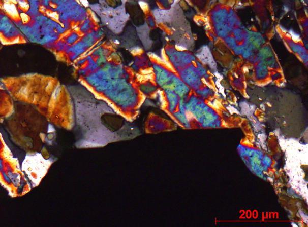 A arsenopirita ocorre em cristais bem formados, chega a 1 mm e sobrecresce comumente a turmalina (Figura