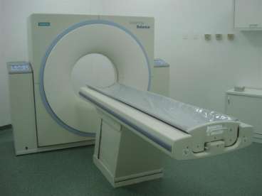 , 2007), o aparelho de TC convencional tem três principais componentes: A) o gantry, no interior onde se localiza o tubo de RX e um anel de cristais de cintilação que detectam a radiação; B) a mesa