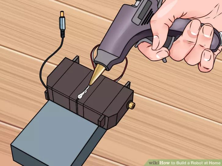 4 Affix the servos with your tape or glue. Make sure that they are solidly attached to the battery pack.