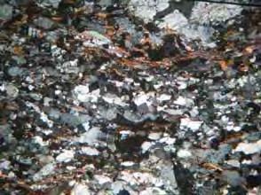 Os cristais de quartzo ocorrem comumente em faixas de até 1,5 mm de espessura intercaladas a bandas de feldspato e plagioclásio; ocorrem também em menor quantidade em meio aos cristais de feldspato.