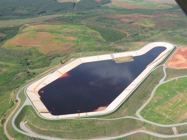 A Figura 10 mostra a instalação dos painéis de geogrelhas, as Figuras 11 e 12 mostram vistas panorâmicas da obra em diferentes estágios e a Figura 13 apresenta uma vista aérea da ARB 7 em operação.