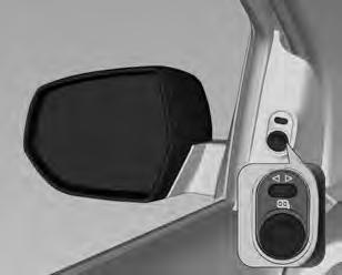 O controle para os espelhos elétricos se localiza no acabamento da porta do lado do motorista.