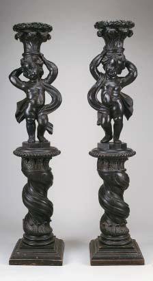 549 550 549 PUTTI, par de esculturas em castanho entalhado suportadas por colunas torsas, portuguesas, séc.