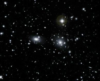 B: o aglomerado binério é dominado por um par de galáxias